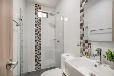 a white bathroom with a toilet and a shower at Espectacular apartamento en Itagui in Itagüí
