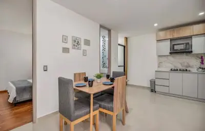 a kitchen and dining room with a table and chairs at Espectacular apartamento en Itagui in Itagüí