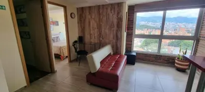 a living room with a couch and a window at Laureles 16th floor stylish Spring City Treat in Medellín