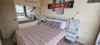 a small bedroom with a bed and a mirror at Laureles 16th floor stylish Spring City Treat in Medellín