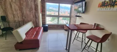 a living room with a couch and a table at Laureles 16th floor stylish Spring City Treat in Medellín
