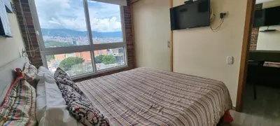 a bedroom with a bed and a large window at Laureles 16th floor stylish Spring City Treat in Medellín