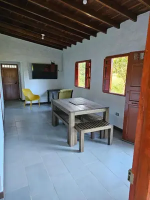 a living room with a wooden table and a bench at Don tranquilo in Concepción