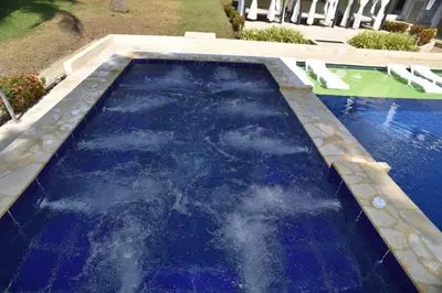 a swimming pool with blue water in a yard at Finca Dubai in San Jerónimo