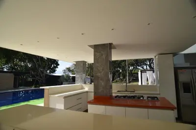 a kitchen with a stove top oven next to a pool at Finca Dubai in San Jerónimo