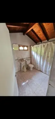 a bathroom with a toilet and a sink at FINCA LA MIEL en Barbosa Antioquia in Barbosa