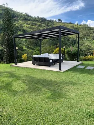 a gazebo with a table and a couch in a yard at FINCA LA MIEL en Barbosa Antioquia in Barbosa