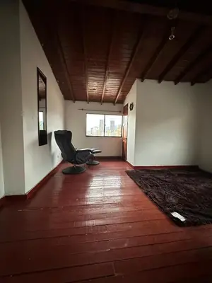 a empty room with a chair in the middle of it at Apto con vista en distrito cultural de Medellín in Medellín
