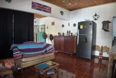 a living room with a refrigerator and a couch at Casa de pesca in Honda