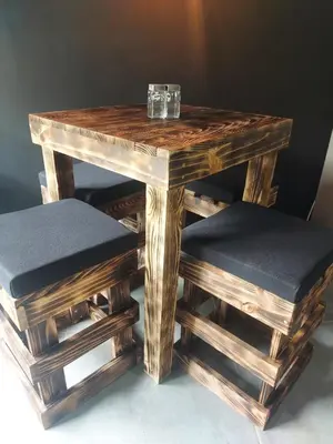 a wooden table and two stools with glasses on it at Stylish Laureles Loft in Medellin in Medellín