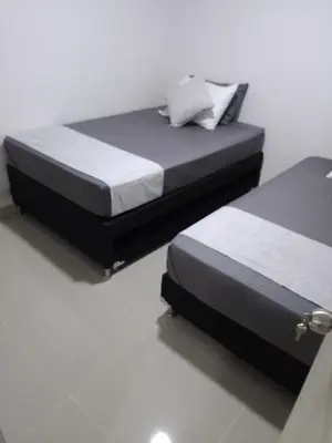 two twin beds in a room with at Encantador alojamiento en San Jerónimo in San Jerónimo