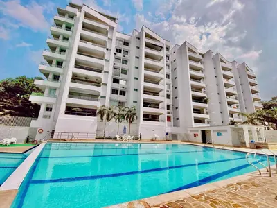 a swimming pool in front of two tall buildings at Encantador alojamiento en San Jerónimo in San Jerónimo
