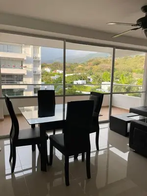 a dining room with a table and chairs and a large window at Encantador alojamiento en San Jerónimo in San Jerónimo