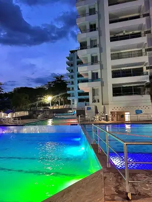 a swimming pool in front of a building at night at Encantador alojamiento en San Jerónimo in San Jerónimo