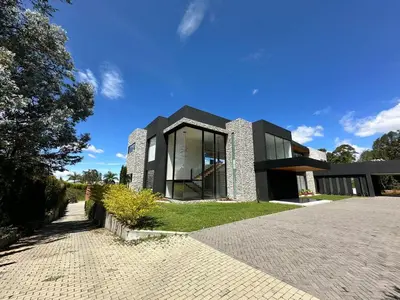 a large black house with a large window at Casa en Rionegro, a pocos minutos del aeropuerto in Rionegro