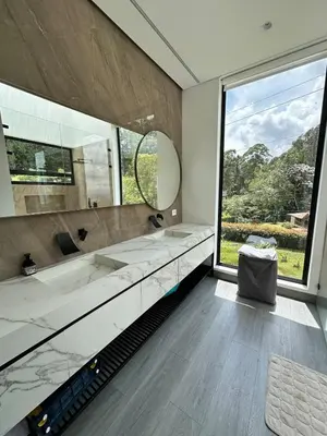 a bathroom with two sinks and a large window at Casa en Rionegro, a pocos minutos del aeropuerto in Rionegro