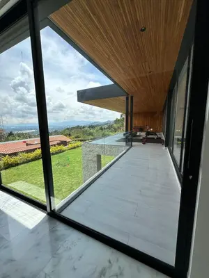 a view from the inside of a house with a large window at Casa en Rionegro, a pocos minutos del aeropuerto in Rionegro
