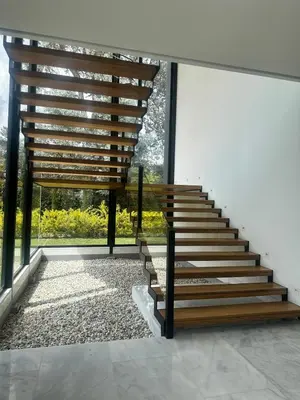 a staircase in a house with a large window at Casa en Rionegro, a pocos minutos del aeropuerto in Rionegro