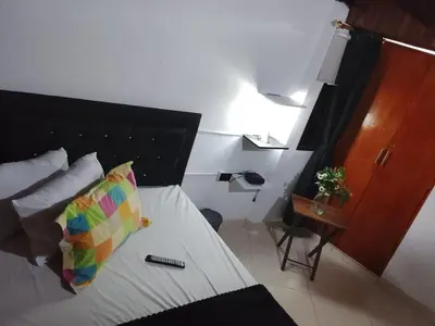 a bedroom with a bed with a pillow and a table at Apartamento Medellin Cordova in Medellín