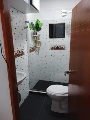 a bathroom with a toilet and a sink at Apartamento Medellin Cordova in Medellín