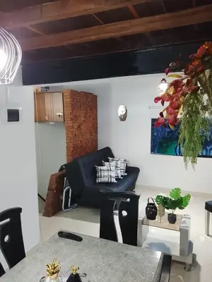 a living room with a couch and a table at Apartamento Medellin Cordova in Medellín