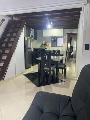 a kitchen and dining room with a table and chairs at Apartamento Medellin Cordova in Medellín
