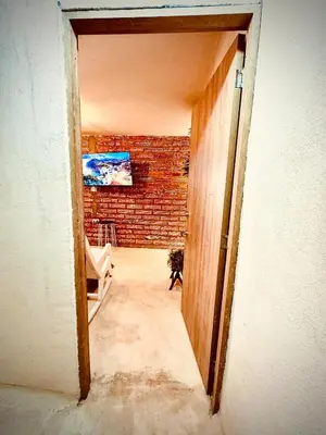 an open door to a room with a brick wall at The best of Envigado, close to everything in Envigado