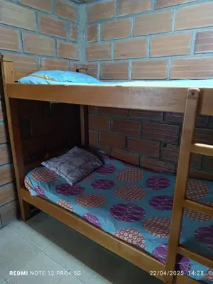 a bunk bed in a brick wall at Finca Arcanos Celeste in Barbosa