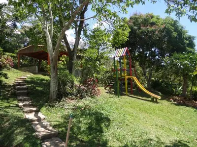 a playground in a yard with a slide at Finca Arcanos Celeste in Barbosa
