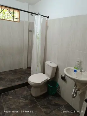 a bathroom with a toilet and a sink at Finca Arcanos Celeste in Barbosa
