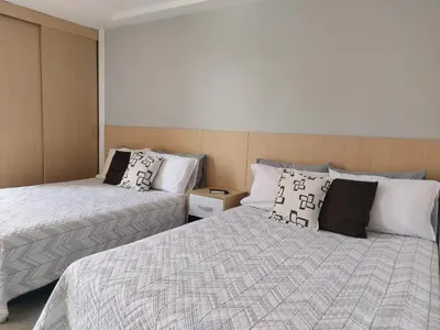two beds sitting next to each other in a room at Medellin, Bring your toothbrush, in Laureles in Medellín