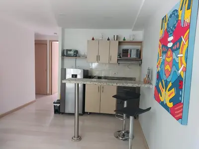 a kitchen with a counter and stools in a room at Medellin, Bring your toothbrush, in Laureles in Medellín
