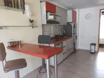 a kitchen with a red counter top in a room at Best apartment, best location, Laureles Paradise in Medellín