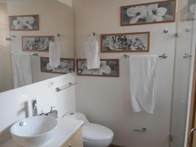 a bathroom with a sink and a toilet and towels at Best apartment, best location, Laureles Paradise in Medellín