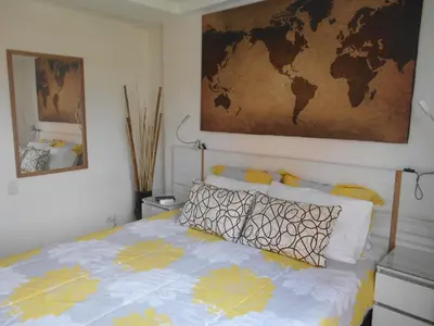 a bedroom with a bed with a map on the wall at Best apartment, best location, Laureles Paradise in Medellín
