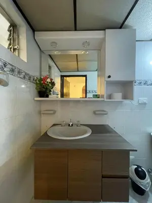 a bathroom with a sink and a mirror at Hotel boutique san pablo H5 in Medellín