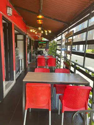 a restaurant with red chairs and a wooden table at Hotel boutique san pablo H5 in Medellín