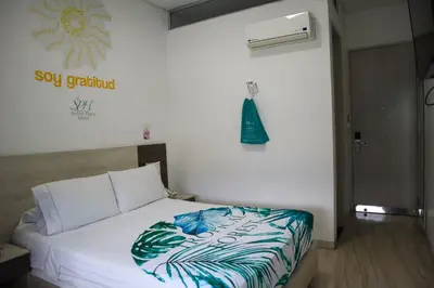 a bedroom with a bed in a room at Hotel Sixtina Plaza Medellin in Medellín