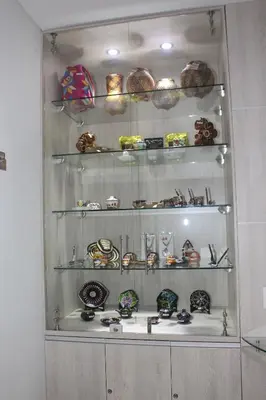 a glass shelf with plates and bowls on it at Hotel Sixtina Plaza Medellin in Medellín