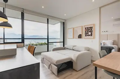 a living room with a couch and a bed at Grand By Jalo in Medellín