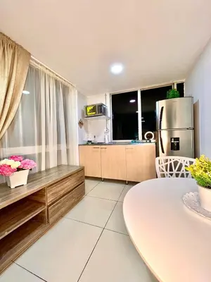 a large kitchen with a table and a refrigerator at Digital nomads, everything close Ac Wi-fi fast in Medellín