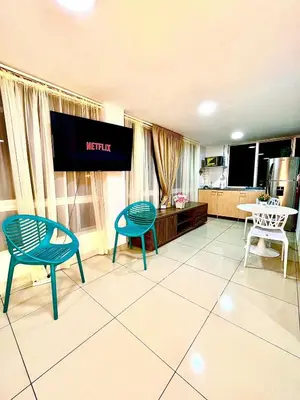 a living room with two chairs and a flat screen tv at Digital nomads, everything close Ac Wi-fi fast in Medellín