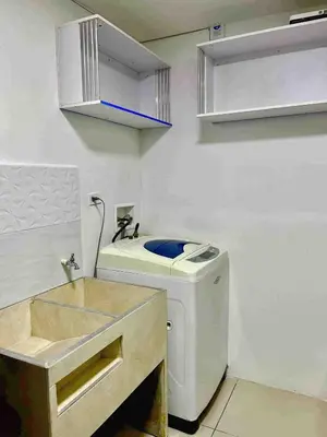 a small kitchen with a washing machine and a sink at Digital nomads, everything close Ac Wi-fi fast in Medellín