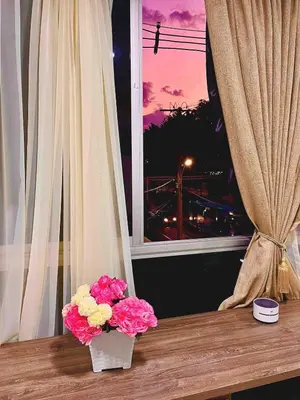 a vase of flowers sitting on a table next to a window at Digital nomads, everything close Ac Wi-fi fast in Medellín