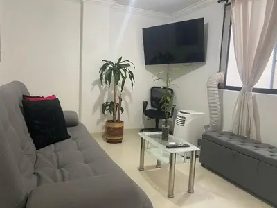 a living room with a couch and a table at Apartamento renovado parque La Floresta, reserva minimo de 21 dias in Medellín