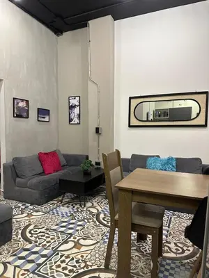 a living room with a couch and a table at Apartamento parque poblado lleras jacuzzi aire provenza in Medellín