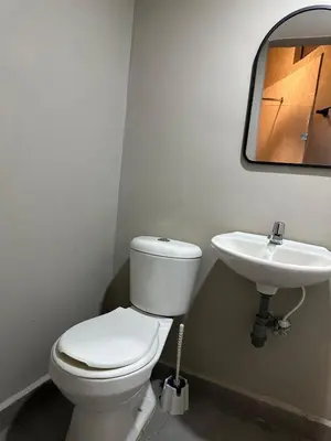 a bathroom with a toilet and a sink at Apartamento parque poblado lleras jacuzzi aire provenza in Medellín
