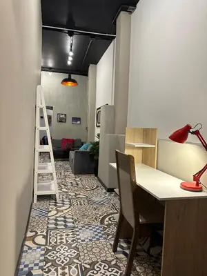 a room with a desk and chairs and a ladder at Apartamento parque poblado lleras jacuzzi aire provenza in Medellín