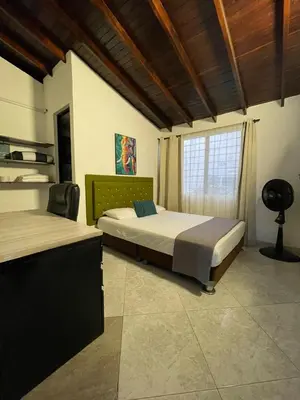 a bedroom with two beds and a window at Hotel boutique san pablo H4 in Medellín
