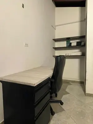 a desk with a black chair and a desk with at Hotel boutique san pablo H4 in Medellín